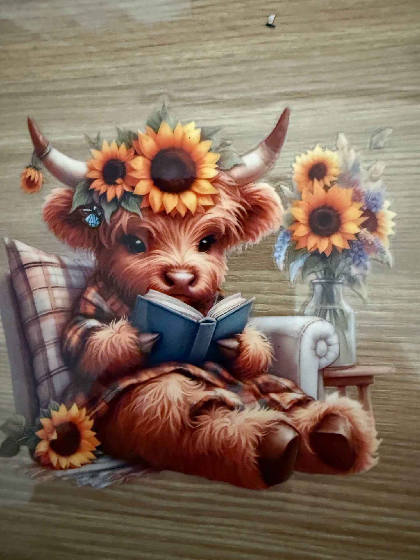 Decal - Cow reading a blue book while sitting in a chair